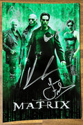 A cast autographed photo poster from the 1999 movie, The Matrix. Signed photo of Keanu Reeves, Laurence Fishburne, Carrie-Anne Moss and Joe Pantoliano in silver ink marker signatures. Photograph The Matrix autographs for sale on 8x12 inch picture.