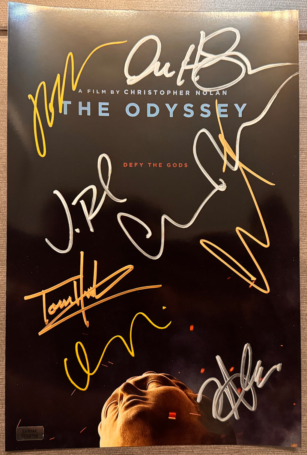 A cast autographed movie poster for Christopher Nolan's film 'The Odyssey'. Signed photo of Jon Bernthal, Matt Damon, Tom Holland, Zendaya, Anne Hathaway, Charlize Theron, Robert Pattinson and Christopher Nolan in silver and gold ink marker signatures. Photograph autographs for sale on 8x12 inch picture.