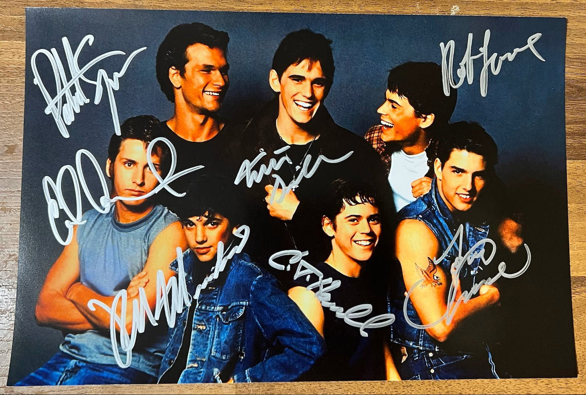 An autographed photo of the movie The Outsiders. signed photograph of Patrick Swayze, Tom Cruise, Rob Lowe, Matt Dillon, Ralph Macchio, Thomas C. Howell and Emilio Estevez in silver ink marker signatures. poster is 8x12 inches in size. Autographs for sale.