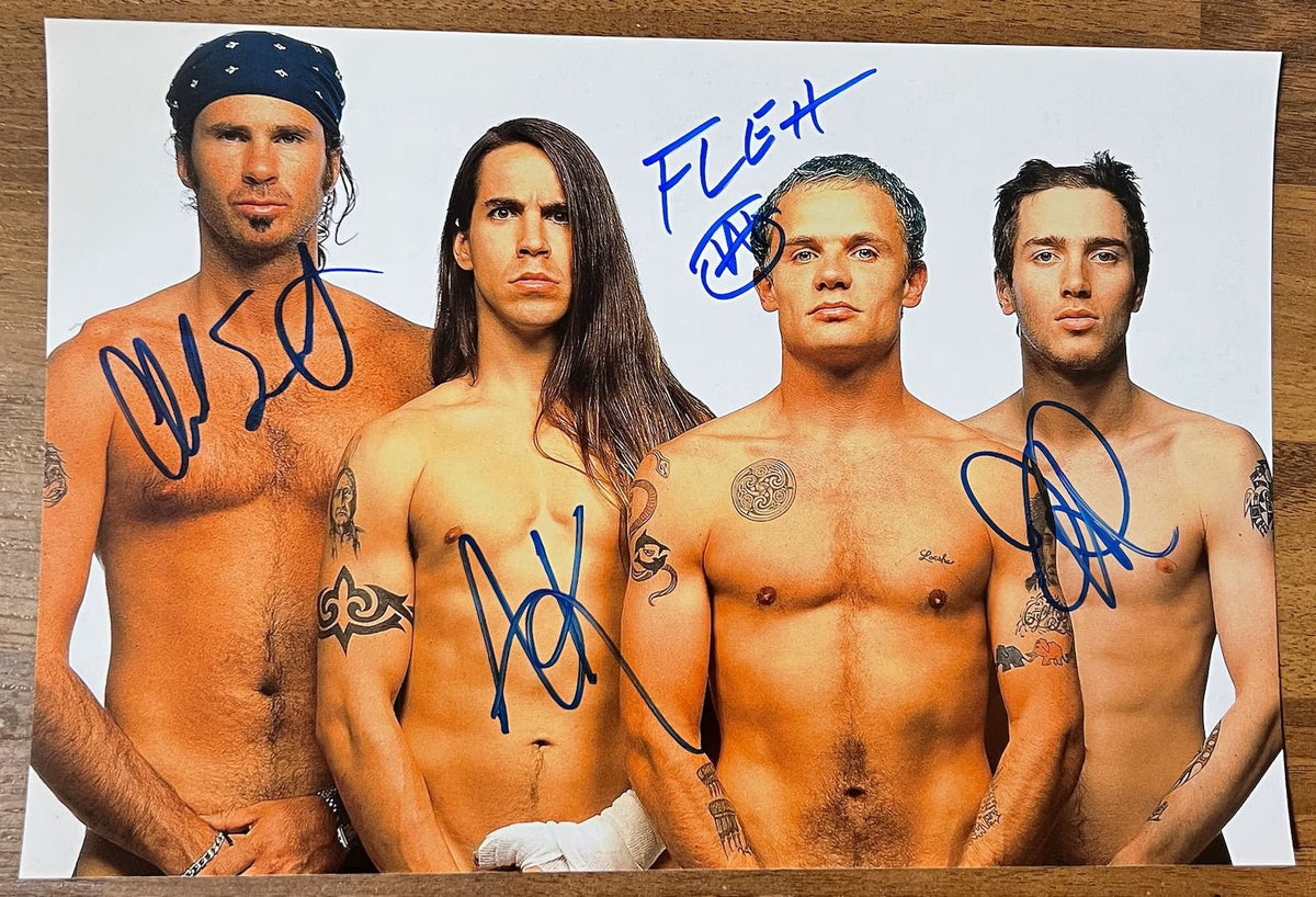 an autographed poster of the band the red hot chili peppers. Signed photo of Anthony Kiedis, Flea, Chad Smith and John Frusciante in blue ink marker signatures. Photograph autographs for sale on an 8x12 inch picture.