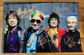 an autographed photo of the band The Rolling Stones. Signed poster of Mick Jagger, Keith Richards, Charlie Watts and Ronnie Wood in gold ink marker signatures. Photograph autographs for sale on 8x12 inch picture.