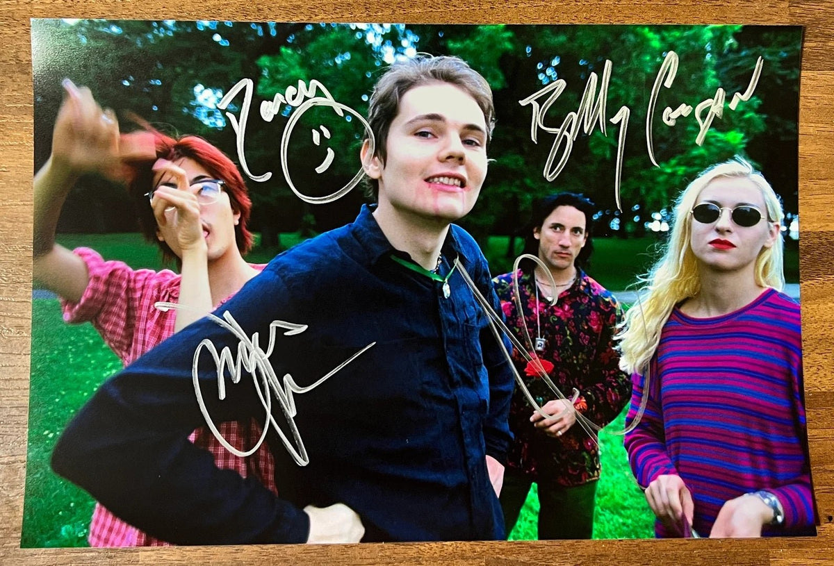 an autographed photo of band The Smashing Pumpkins. Signed poster by Billy Corgan, James Iha, Jimmy Chamberlin and D'arcy Wretzky in silver ink markers signatures. Photograph autographs for sale on 8x12 inch picture.