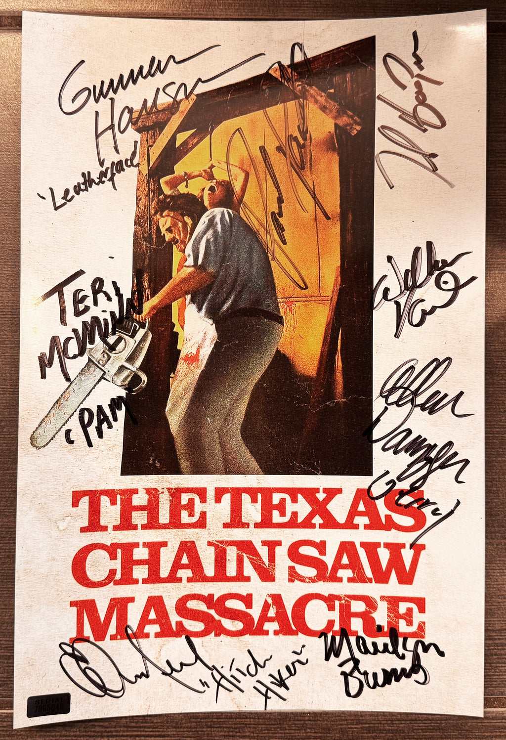 A cast autographed vintage movie photo poster for 'The Texas Chain Saw Massacre'. Signed photograph of Tobe Hooper, Gunnar Hansen, Marilyn Burns, Edwin Neal, Paul Partain, Allen Danziger, Teri McMinn and William Vai in black ink marker signatures. Photograph autographs for sale on 8x12 inch picture.