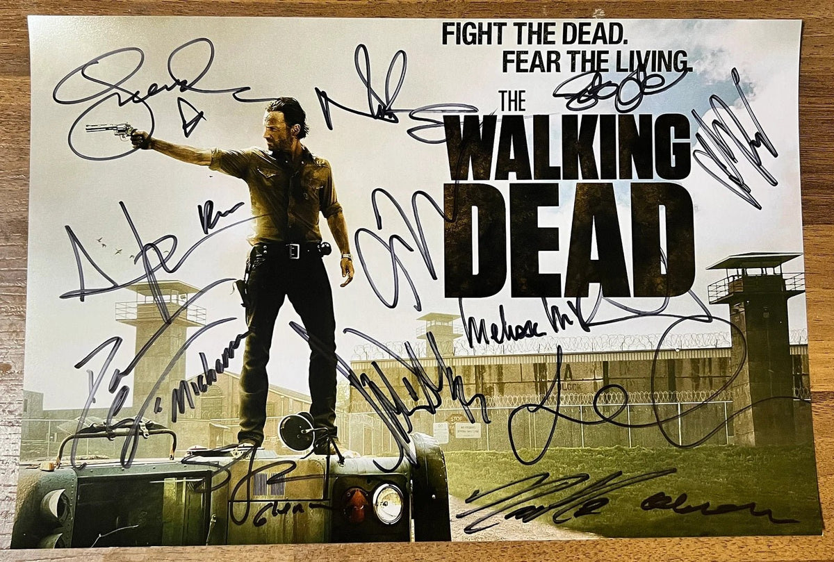 A cast autographed poster of the television series, The Walking Dead. Signed photo of Andrew Lincoln, Norman Reedus, Jeffrey Dean Morgan, Danai Gurira, Chandler Riggs, Lauren Cohan, Steven Yeun, Christian Serratos, Josh McDermitt, Melissa McBride, Seth Gilliam and Ross Marquand in black ink markers signatures. Photograph autographs for sale on 8x12 inch picture. Rick on bus.