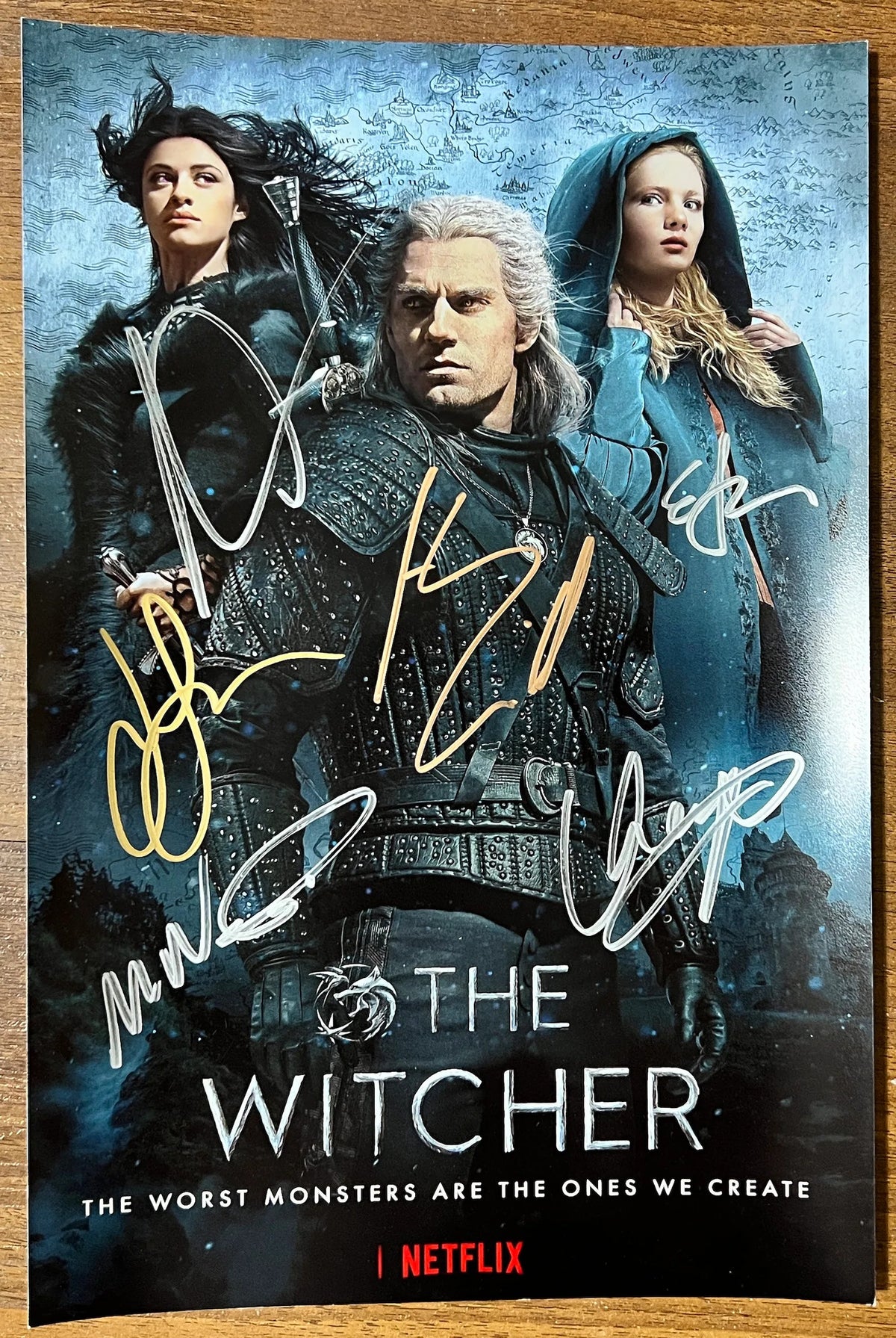 A cast autographed photo poster of the netflix television series, The Witcher. Signed photo of Henry Cavill, Freya Allan, Anya Chalotra, Mimi Ndiweni, Eamon Farren and Joey Batey in silver and gold ink marker signatures. Photograph autographs for sale on 8x12 inch picture.