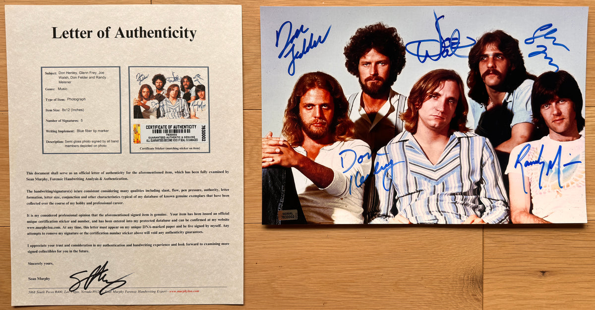 an autographed photo of the band The Eagles. signed photograph of Don Henley, Glenn Frey, Joe Walsh, Don Felder and Randy Meisner in blue ink. poster autographs for sale with COA.