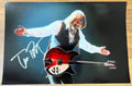 photograph poster signed by Tom Petty and the Heartbreakers. autographed in silver ink on an 8x12 inch photo. autographs for sale on collectible picture.