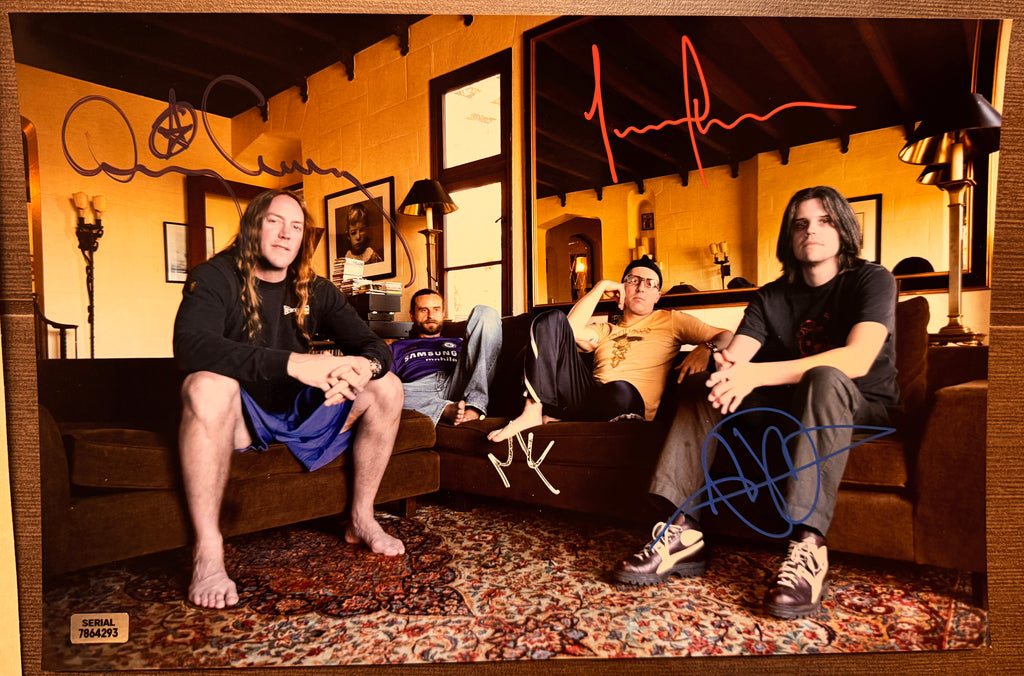 An autographed poster of the rock band Tool. Signed photo of Maynard James Keenan, Adam Jones, Danny Carey and Justin Chancellor in red purple white and blue paint pen ink marker signatures. Photograph autographs for sale on 8x12 inch picture.