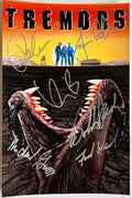 A cast signed 'Tremors' movie poster. Autographed photo by Kevin Bacon, Fred Ward, Finn Carter, Michael Gross, Reba McEntire and Bobby Jacoby in silver ink marker signatures. Photograph autographs for sale on 8x12 inch picture.