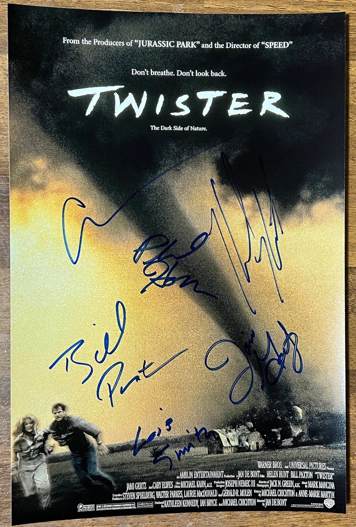 A cast signed movie poster for the film 'Twister'. Signed photo of Bill Paxton, Helen Hunt, Philip Seymour Hoffman, Cary Elwes, Jami Gertz and Lois Smith in blue ink marker signatures. Photograph autographs for sale on 8x12 inch picture.
