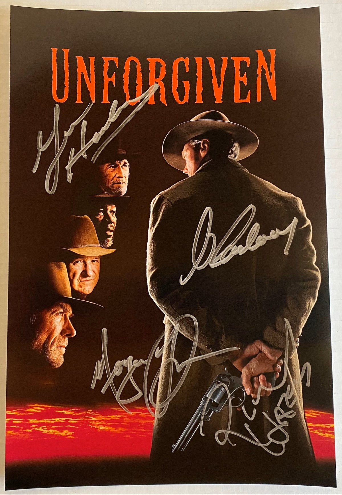 A cast autographed photo poster of the movie, Unforgiven. Signed photo of Clint Eastwood, Morgan Freeman, Gene Hackman and Richard Harris in silver ink markers signatures. photograph Clint Eastwood autographs for sale on 8x12 inch picture.