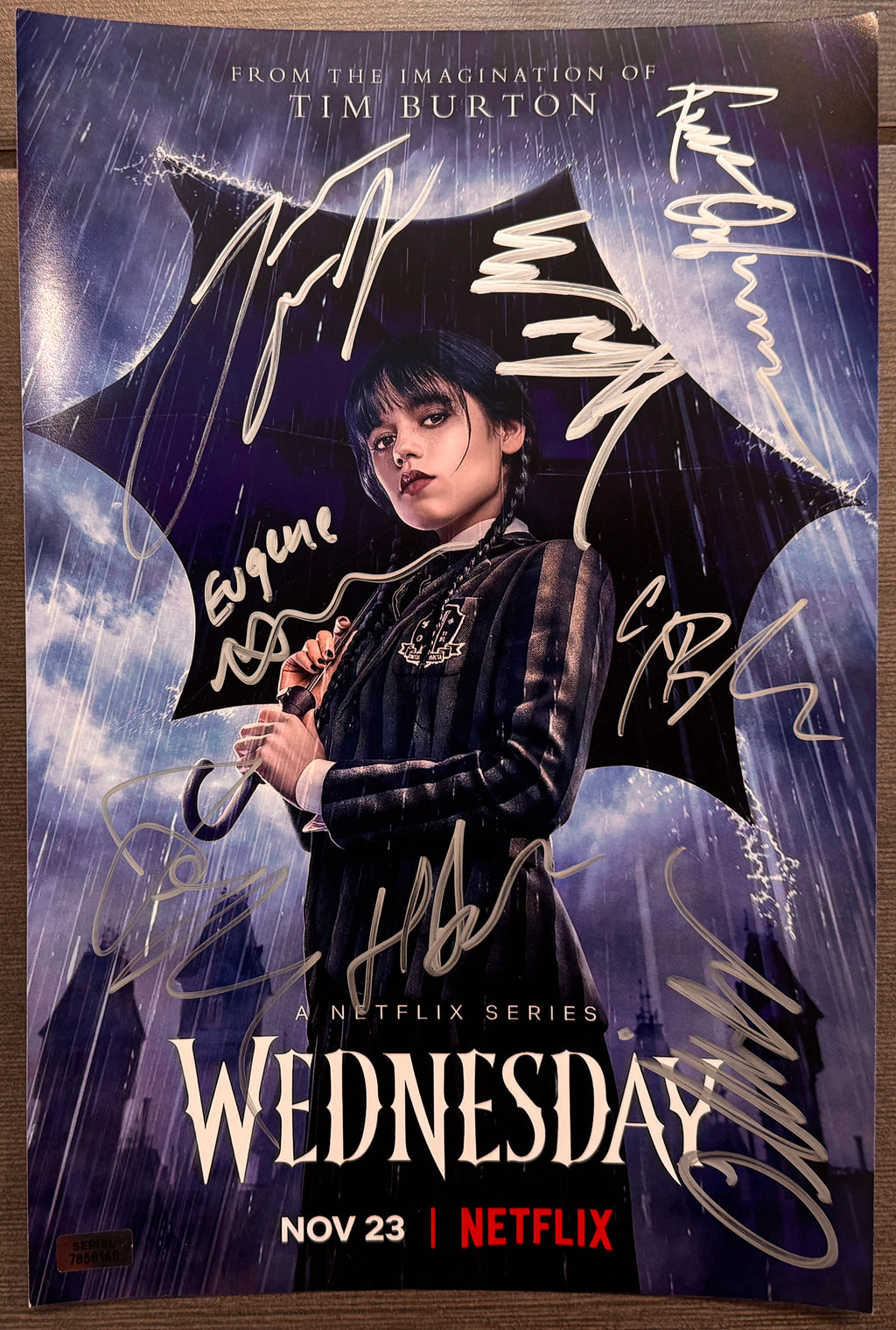 A cast autographed photo poster of the Netflix television series, Wednesday. Signed photo of Jenna Ortega, Emma Myers, Hunter Doohan, Joy Sunday, Georgie Farmer, Moosa Mostafa, Oliver Watson and Isaac Ordonez in silver ink marker signatures. Photograph Wednesday autographs for sale on 8x12 inch picture.