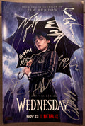 A cast autographed photo poster of the Netflix television series, Wednesday. Signed photo of Jenna Ortega, Emma Myers, Hunter Doohan, Joy Sunday, Georgie Farmer, Moosa Mostafa, Oliver Watson and Isaac Ordonez in silver ink marker signatures. Photograph Wednesday autographs for sale on 8x12 inch picture.