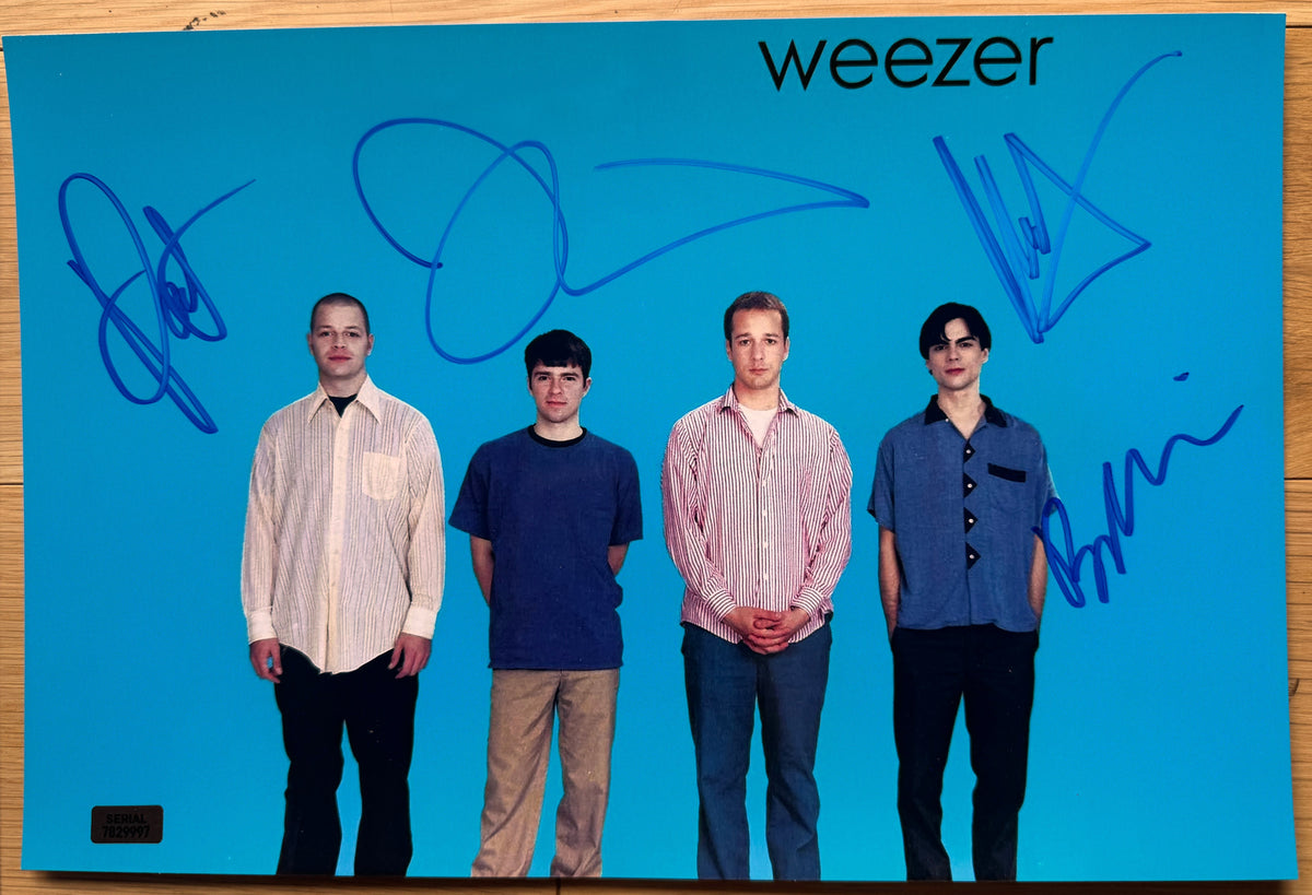 An autographed poster of the band, Weezer. Signed photo of Rivers Cuomo, Patrick Wilson, Brian Bell and Matt Sharp in blue ink marker signatures. Photograph autographs for sale on 8x12 inch picture.