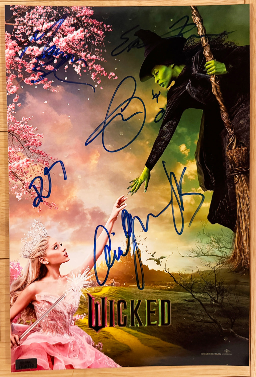 A cast autographed photo poster of the movie, Wicked. Signed photo of Ariana Grande, Cynthia Erivo, Jonathan Bailey, Marissa Bode, Ethan Slater and Bowen Yang in blue ink markers signatures. Photograph ariana grande autographs for sale on 8x12 inch picture.