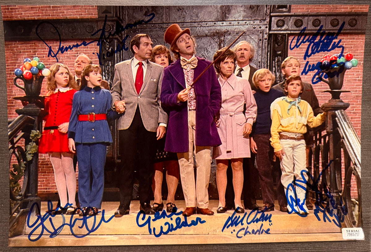 A cast autographed photo poster of the original 1971 movie, Willy Wonka and the Chocolate Factory. Signed photo of Gene Wilder, Peter Ostrum, Denise Nickerson, Julie Dawn Cole, Paris Themmen and Michael Bollner in blue ink marker signatures. Photograph Gene Wilder autographs for sale on 8x12 inch picture.