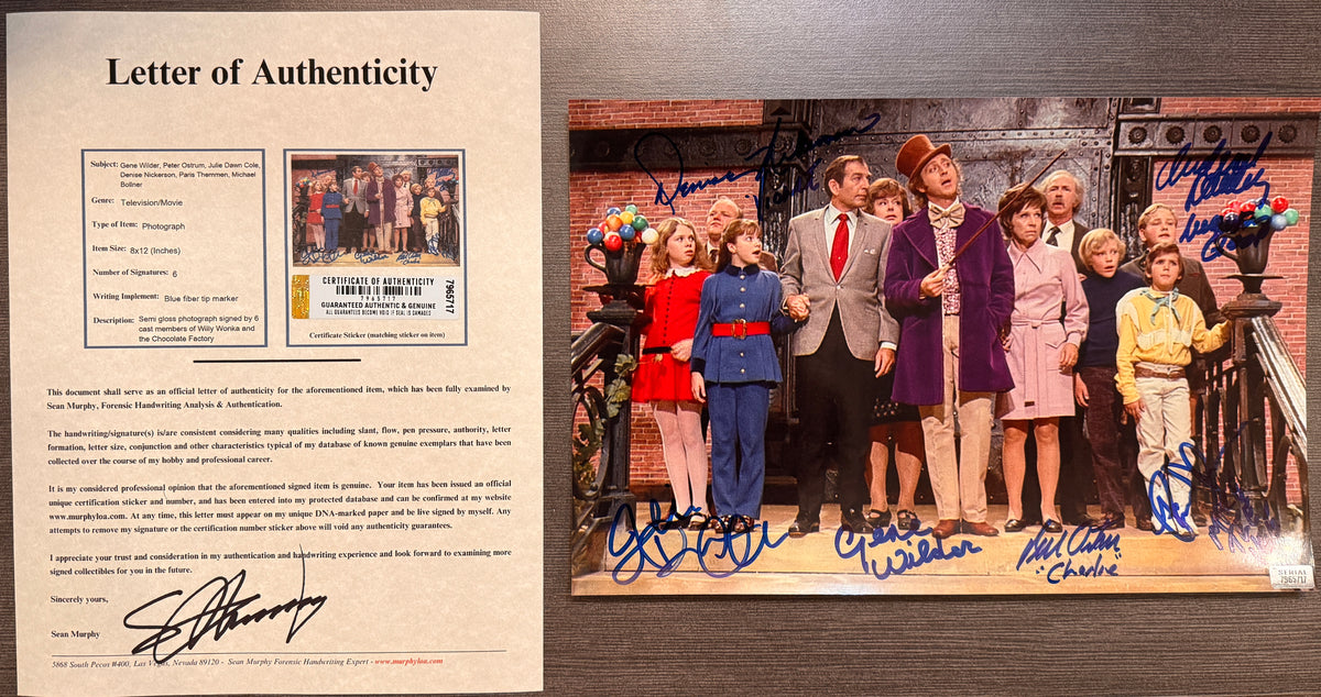 A cast autographed photo poster of the original 1971 movie, Willy Wonka and the Chocolate Factory. Signed photo of Gene Wilder, Peter Ostrum, Denise Nickerson, Julie Dawn Cole, Paris Themmen and Michael Bollner in blue ink marker signatures. Photograph Gene Wilder autographs for sale on 8x12 inch picture with COA.