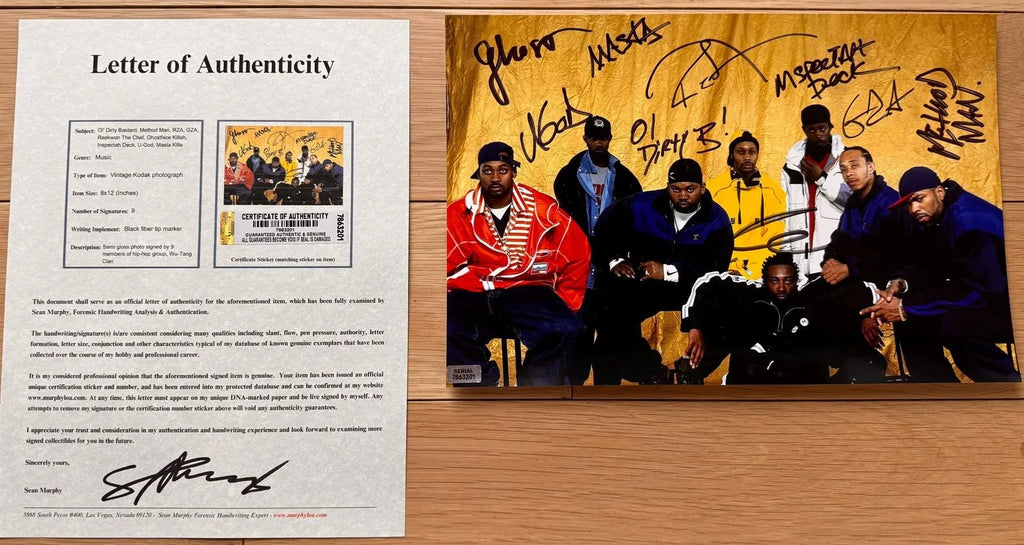 an autographed photo of the rap hip hop group wu-tang clan. photograph is signed in black ink by Ol' Dirty Bastard, Method Man, RZA, GZA, Raekwon The Chef, Ghostface Killah, Inspectah Deck, U-God, Masta Killa. 8x12 inch photograph with COA.