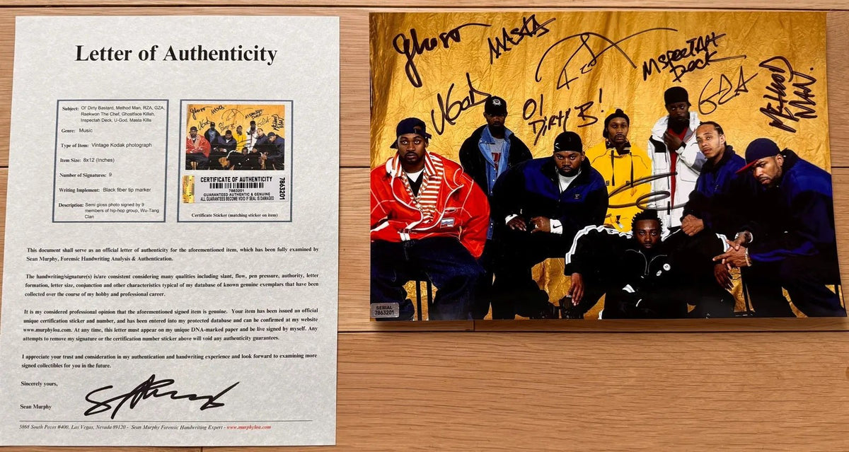 an autographed photo of the rap hip hop group wu-tang clan. photograph is signed in black ink by Ol' Dirty Bastard, Method Man, RZA, GZA, Raekwon The Chef, Ghostface Killah, Inspectah Deck, U-God, Masta Killa. 8x12 inch photograph with COA.